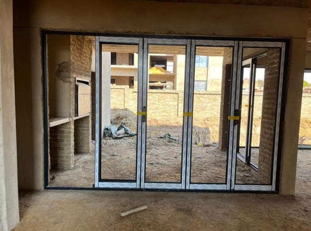 Four-panel aluminium bifold door installed in a home under construction